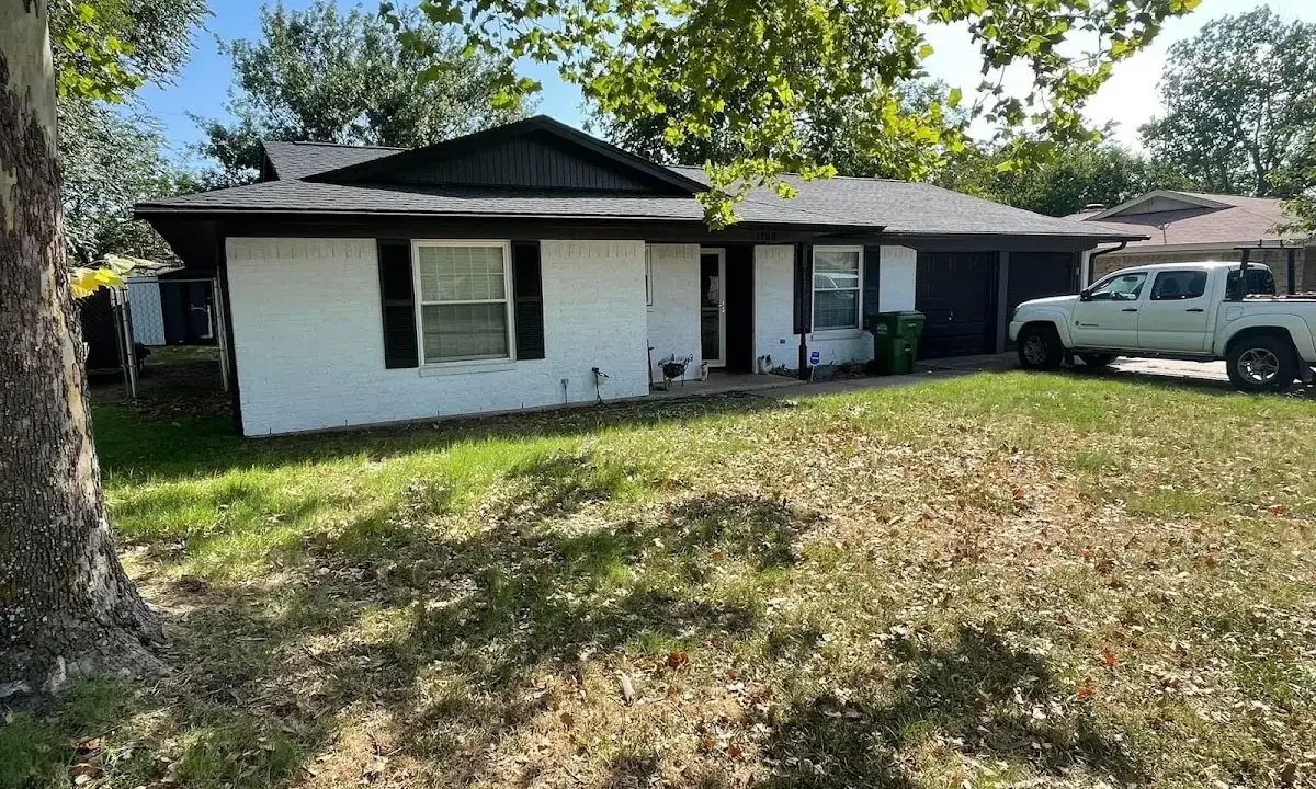 Professional roofing crew working on a residential roof in Willoughby